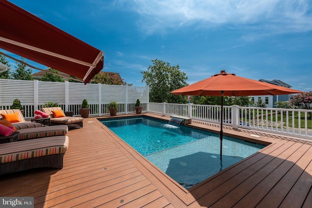 view of pool with pool water feature and a deck