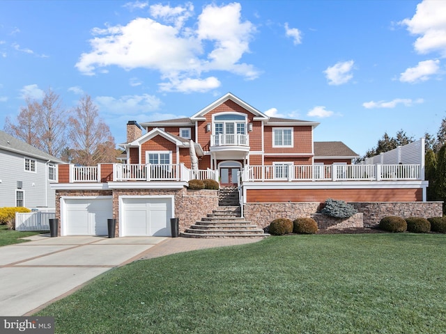 view of front of property featuring a garage and a front lawn