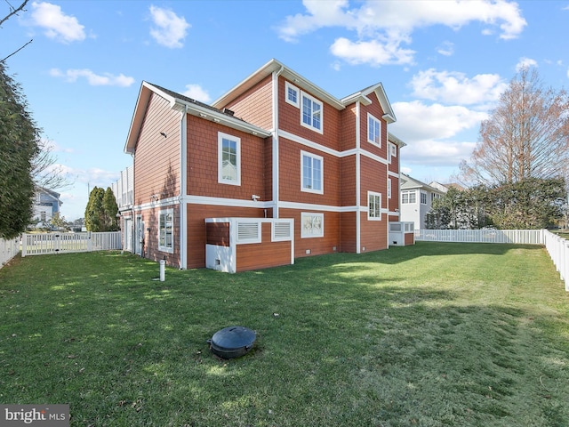 view of side of home with a yard