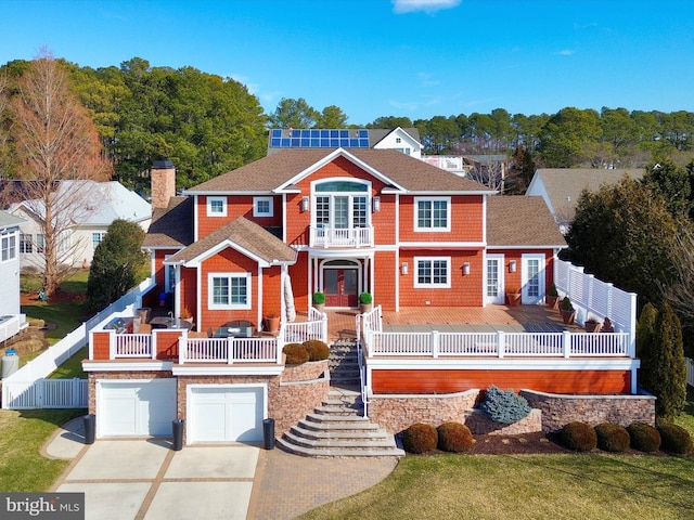 view of front of house with a garage and a balcony