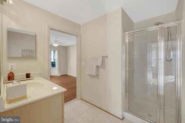 full bath featuring baseboards, vanity, a shower stall, and tile patterned floors