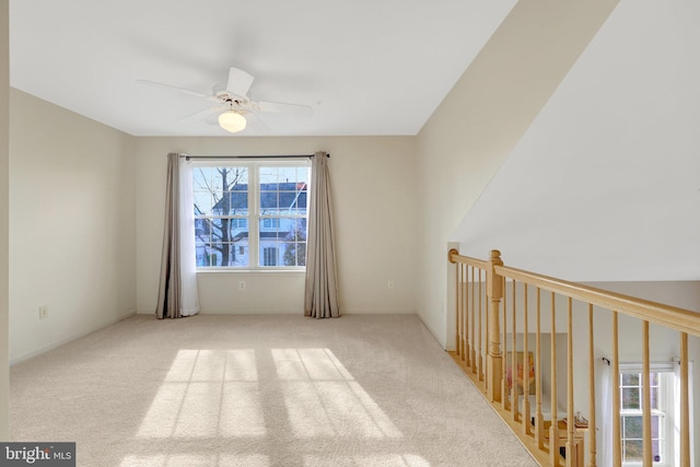 empty room featuring light carpet and ceiling fan