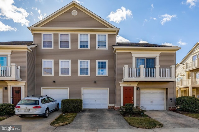 townhome / multi-family property with a garage and concrete driveway