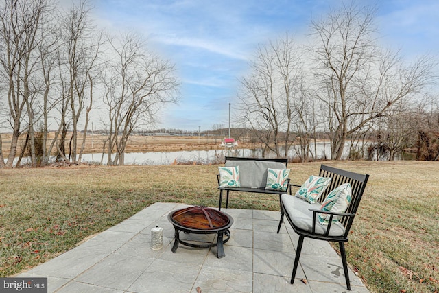 view of patio / terrace featuring a water view and a fire pit