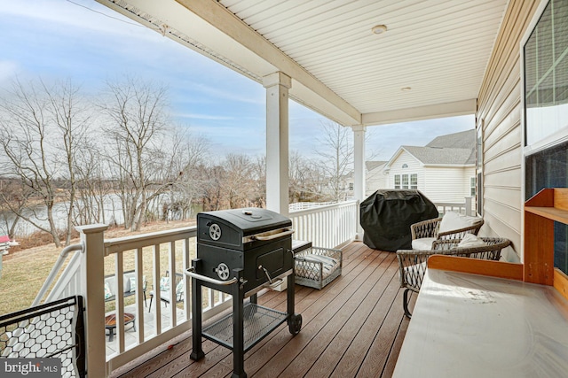 snow covered deck with a grill