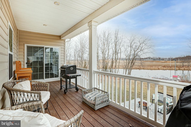 deck with area for grilling and a fire pit