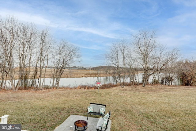 view of yard featuring an outdoor fire pit and a water view