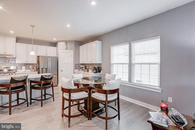 dining space with light wood-type flooring