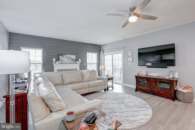 living room with ceiling fan and light wood-type flooring