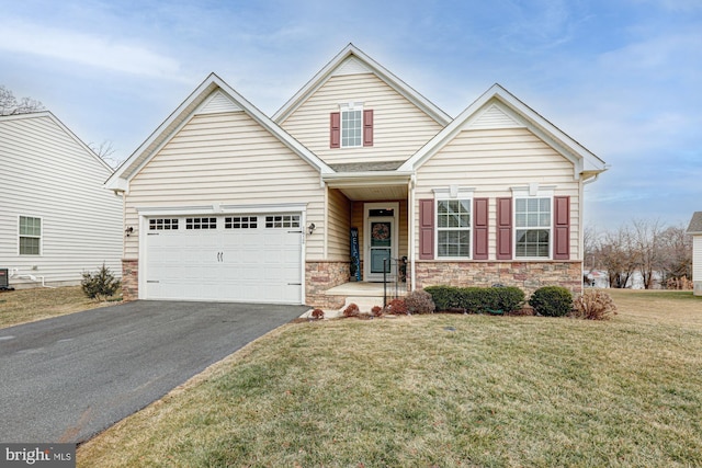 view of front of home featuring a garage, a front yard, and central AC unit