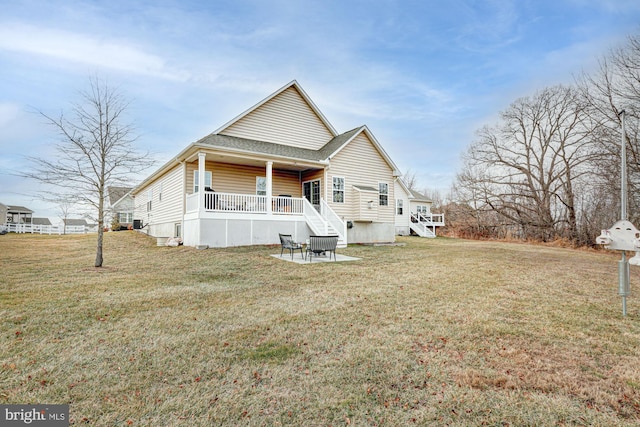 back of house with a lawn