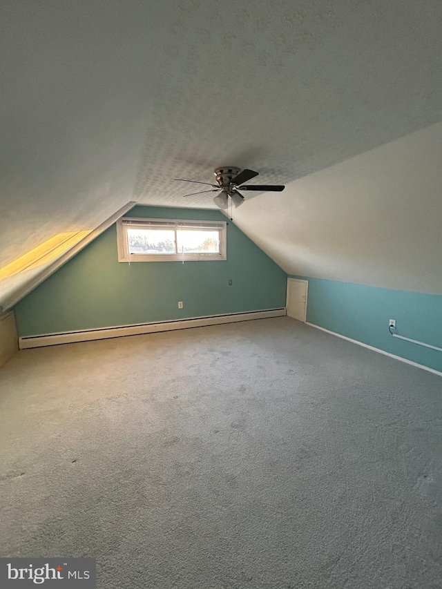 bonus room with a baseboard radiator, lofted ceiling, carpet floors, ceiling fan, and a textured ceiling