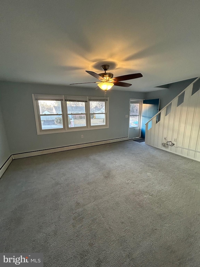 empty room featuring carpet, a baseboard heating unit, and ceiling fan