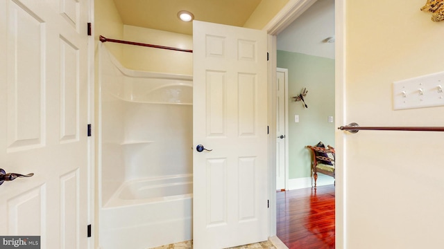 full bath with baseboards and wood finished floors