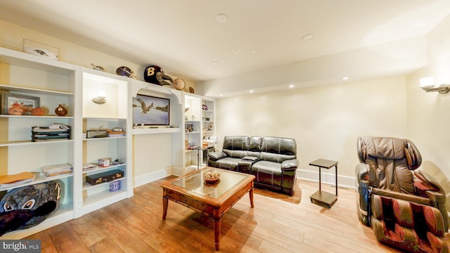 living room with recessed lighting, light wood-style flooring, and baseboards