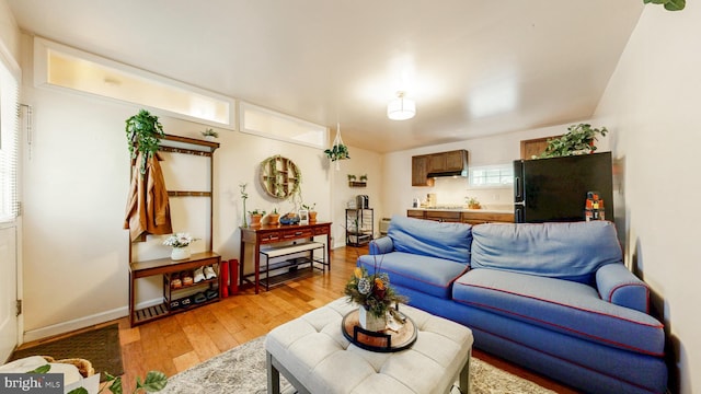 living area featuring light wood-type flooring and baseboards