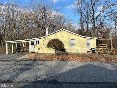 view of side of home with a carport