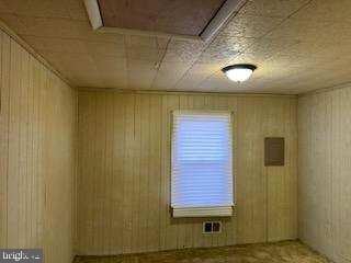 empty room with wooden walls