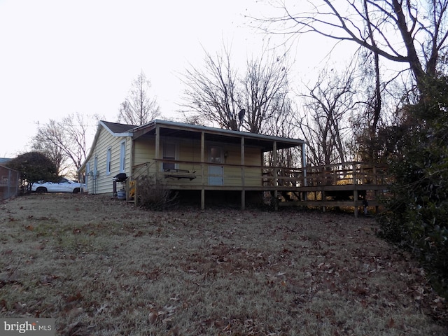 rear view of house with a wooden deck