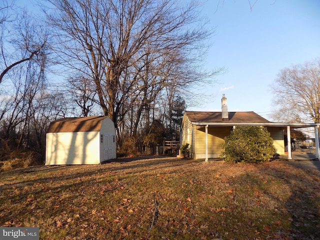 view of home's exterior featuring a storage shed and a carport