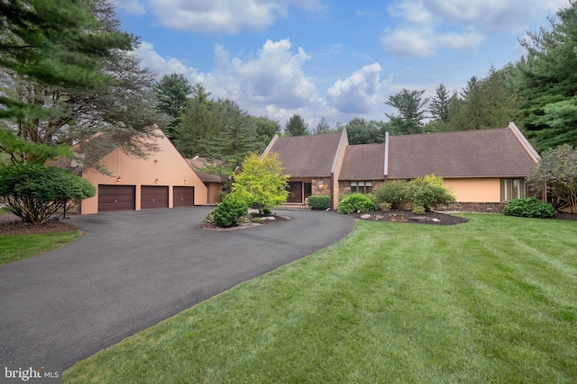 view of front of home with aphalt driveway, a front yard, and stone siding