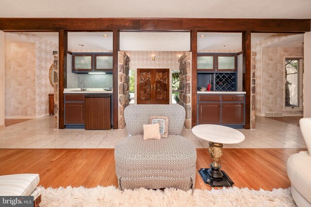 living room featuring light wood-style floors and wet bar