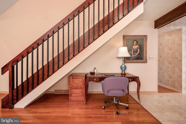 home office with visible vents, beam ceiling, baseboards, and wood finished floors