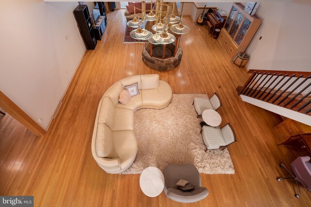 living area featuring stairs, wood finished floors, and baseboards