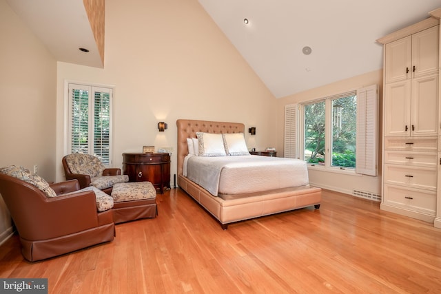 bedroom featuring light wood-style flooring, visible vents, and high vaulted ceiling