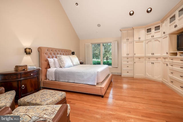 bedroom with light wood finished floors, vaulted ceiling, and recessed lighting