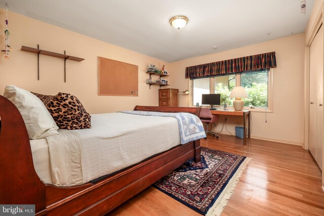 bedroom featuring baseboards and wood finished floors