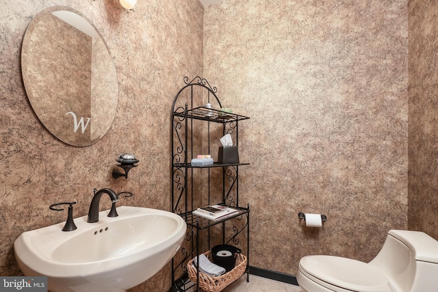 bathroom with toilet and a sink