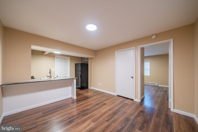 interior space featuring sink, dark hardwood / wood-style floors, and baseboard heating