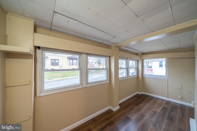 unfurnished room with dark hardwood / wood-style floors