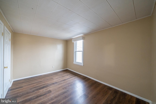 empty room with dark hardwood / wood-style floors