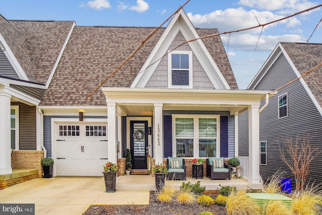 view of front of home featuring a porch and a garage