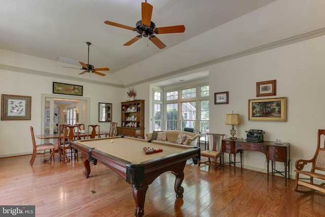 game room with billiards, ornamental molding, vaulted ceiling, and light wood-type flooring