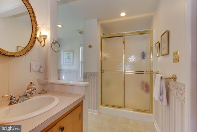 bathroom with tile patterned floors, vanity, and a shower with shower door