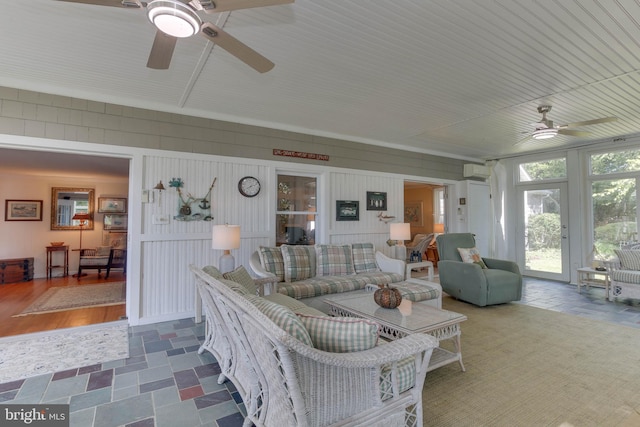 living room featuring ceiling fan and a wall mounted AC