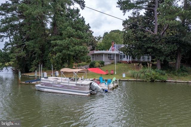 dock area featuring a water view and a yard