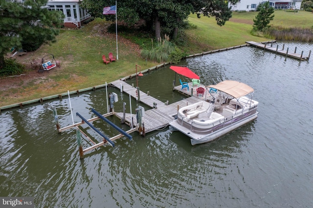 view of dock featuring a yard and a water view