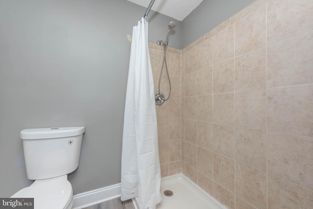 bathroom with toilet and walk in shower