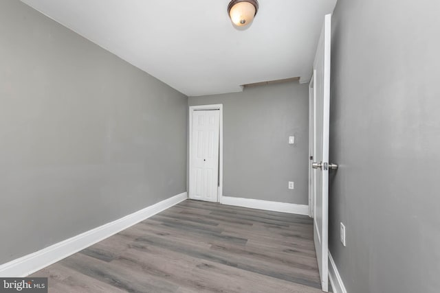 empty room with hardwood / wood-style floors