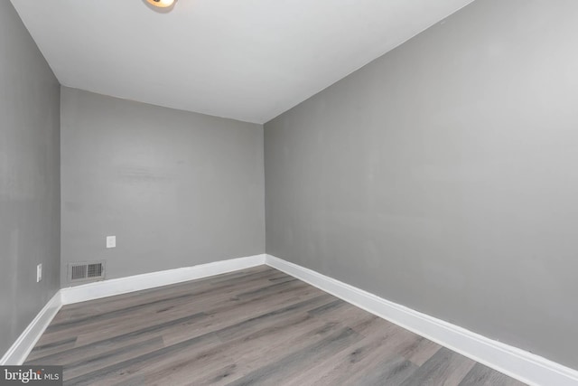 unfurnished room featuring dark hardwood / wood-style floors