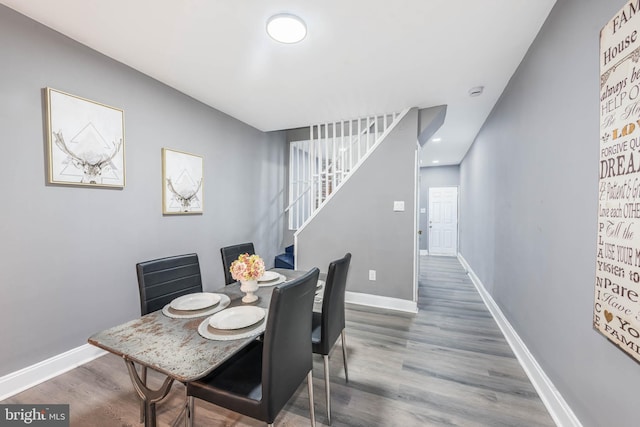 dining space with hardwood / wood-style flooring