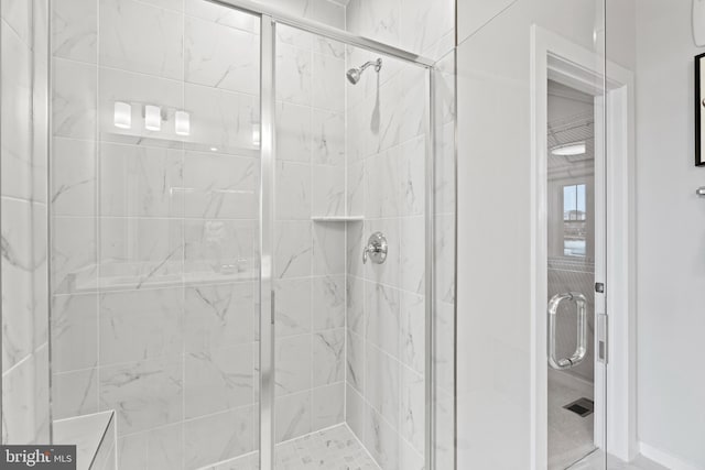 bathroom featuring a shower with door