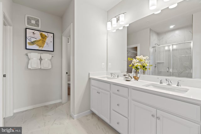 bathroom with vanity, a shower with shower door, and toilet