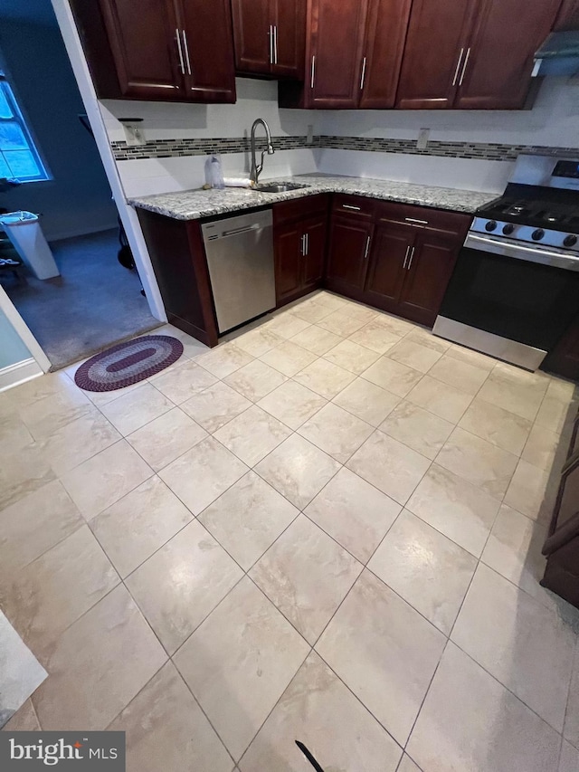 kitchen with tasteful backsplash, sink, stainless steel appliances, and light stone countertops