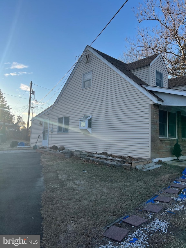 view of home's exterior with a yard