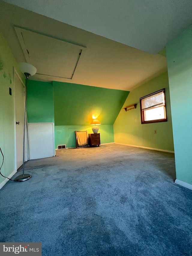 additional living space with carpet floors and vaulted ceiling